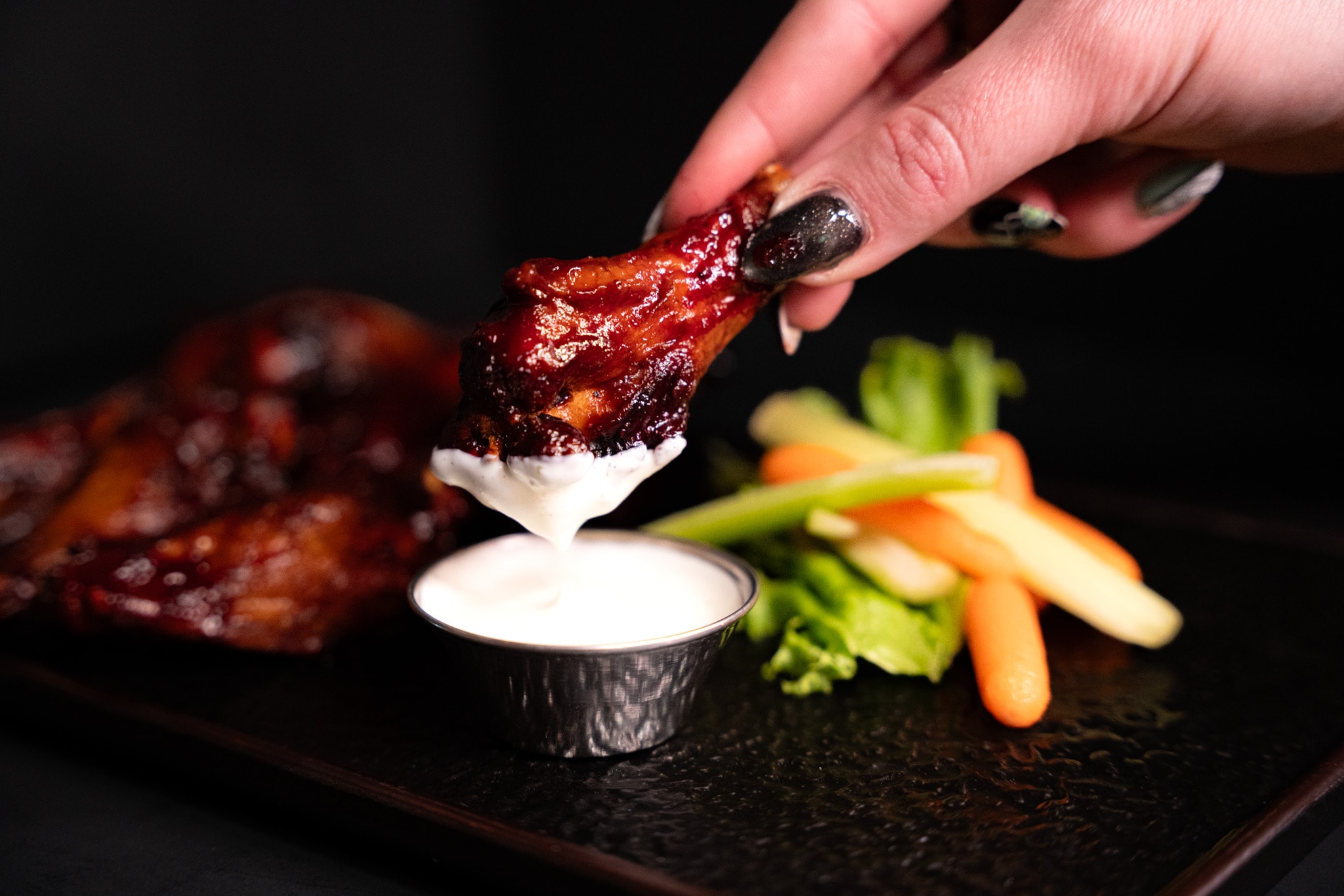 Chicken wings served with dipping sauce and vegetables
