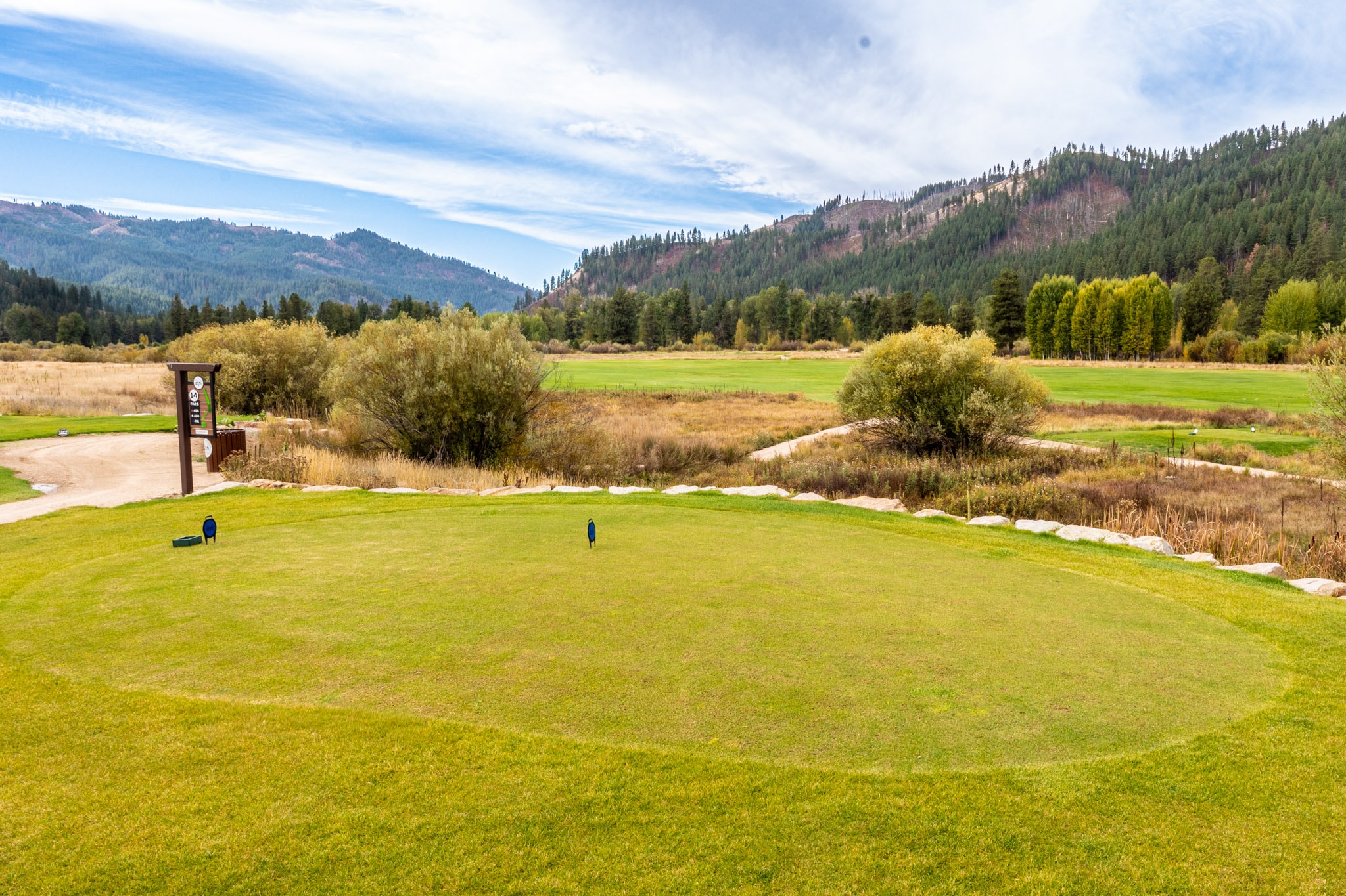 Putting green surrounded by mountain scenery