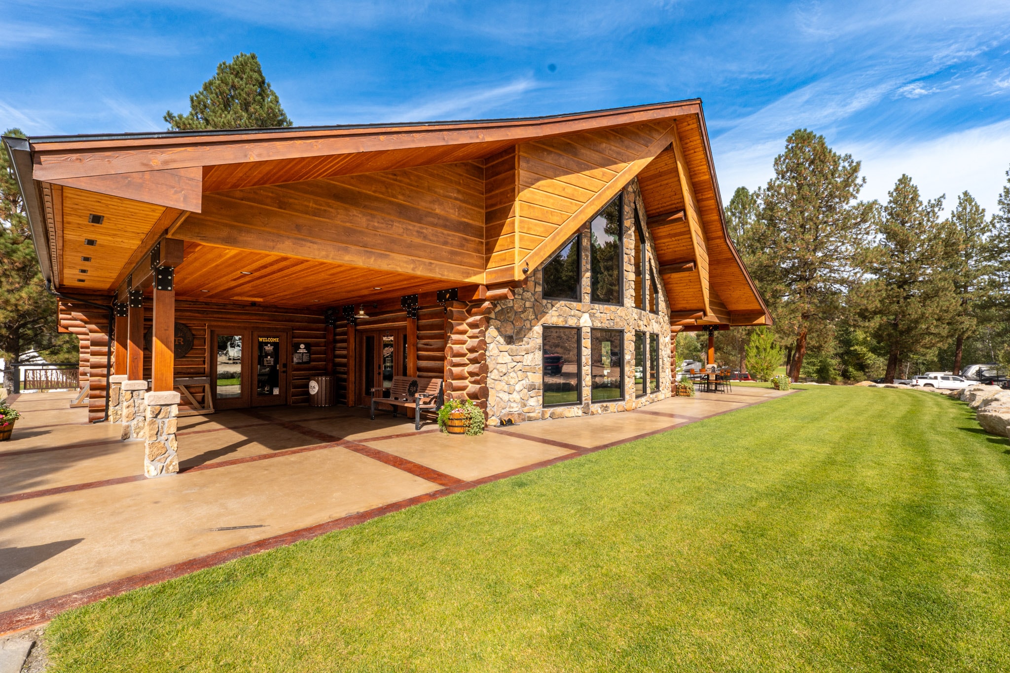 Timber entrance and lawn outside the lodge