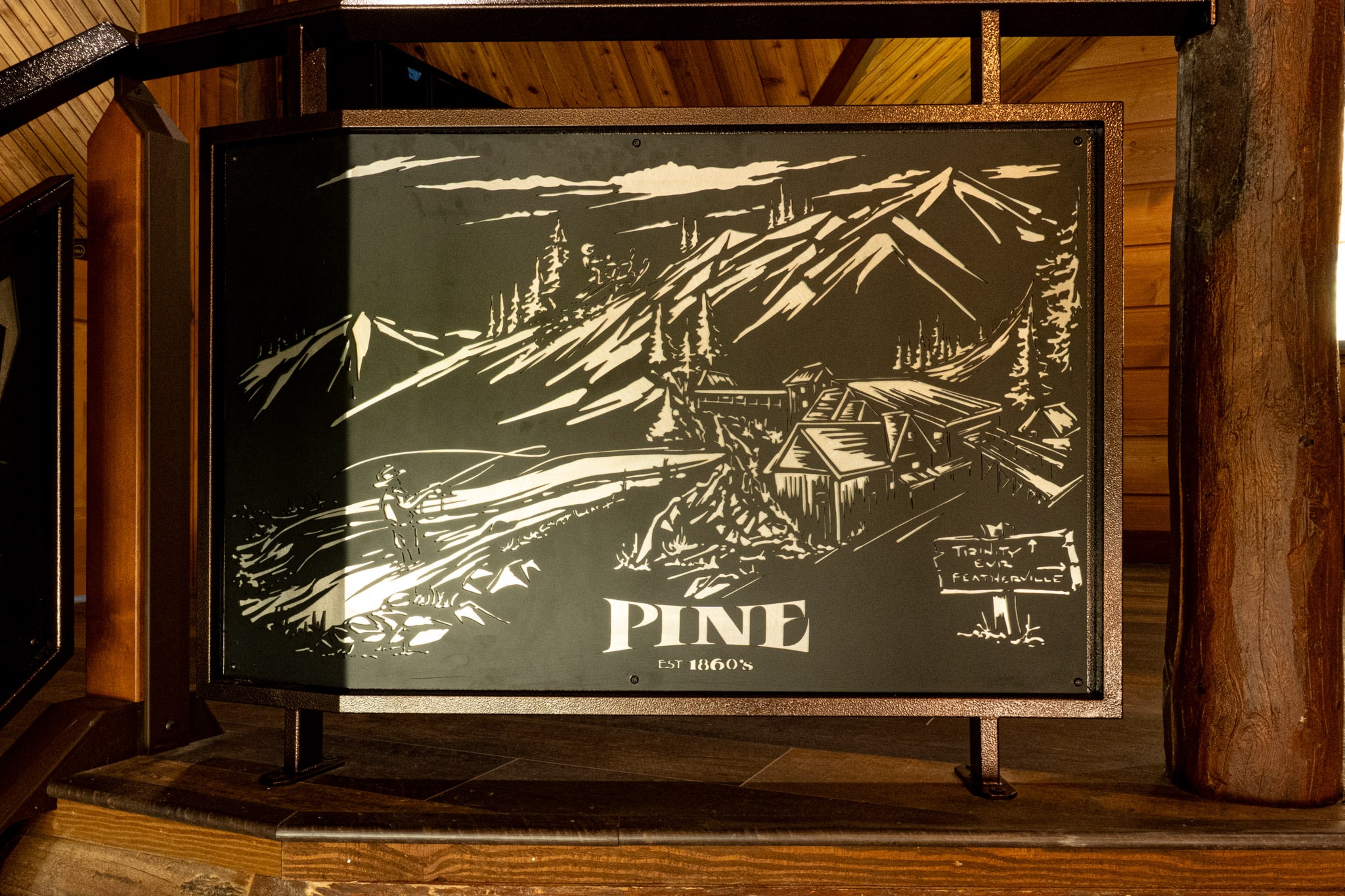 Pine artwork displayed inside the lodge