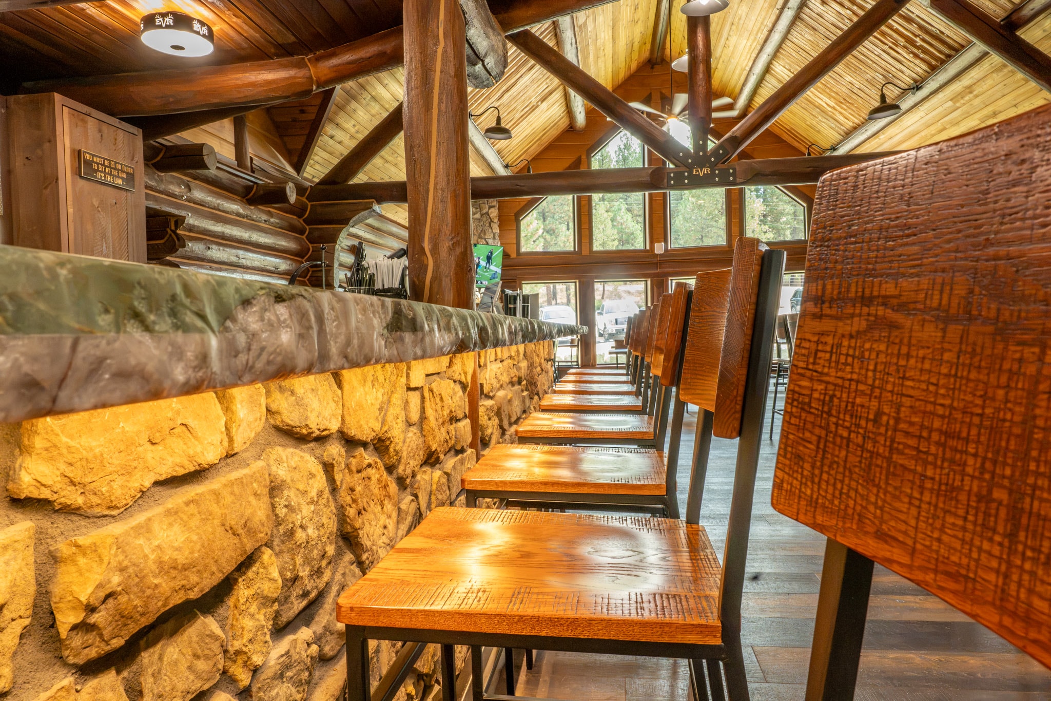 Bar stools along the stone wall
